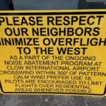 Sign stating "Please Respect Our Neighbors - Minimize Overflight to the West"